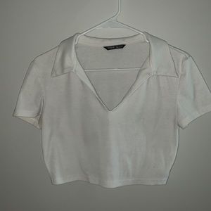 A white collard crop top.